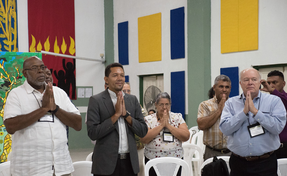 (From left) Bishop Jonathan Holston, the Rev. Carlos Cornejo, Claudete Mora, the Rev. Luis Soto and Bishop Mike McKee use body movement to pray the Lord’s Prayer as part of a devotion given by Bishop Cynthia Moore-Koikoi, at Cristo Resucitado, Ciudad España, Honduras. 