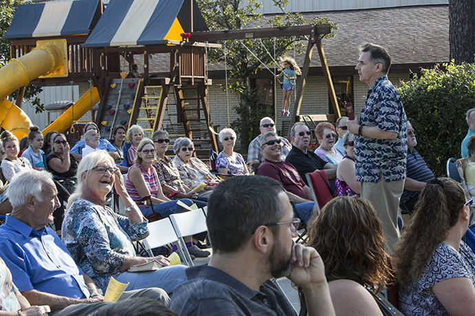 While children enjoy the playground, the adult congregation of Lake Houston United Methodist Church in Huffman, Texas, reacts to the message of the Sunday sermon by the Rev. Frank Coats. Photo by Kathleen Barry, UMNS.