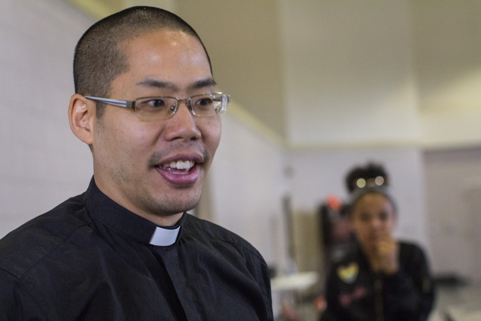 The Rev. Danny Yang, senior pastor at Westbury United Methodist Church in Houston, shows the church gym, where supplies are sorted for flood victims. In the background is volunteer, Zamora Contreras, age 13. The church has found various ways to help since Hurricane Harvey, which flooded Yang out of his home. Photo by Kathleen Barry, UMNS.