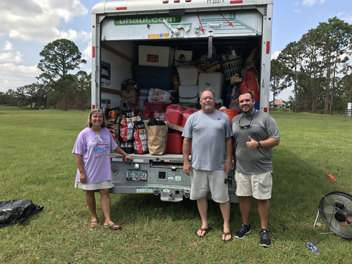 The Rev. John Hill, pastor of Big Pine United Methodist Church, the Rev. Terri Hill, pastor of Key West United Methodist Church, and the Rev. Rob Tucker, associate pastor of Suntree United Methodist Church, stand outside truck filling with donations. 