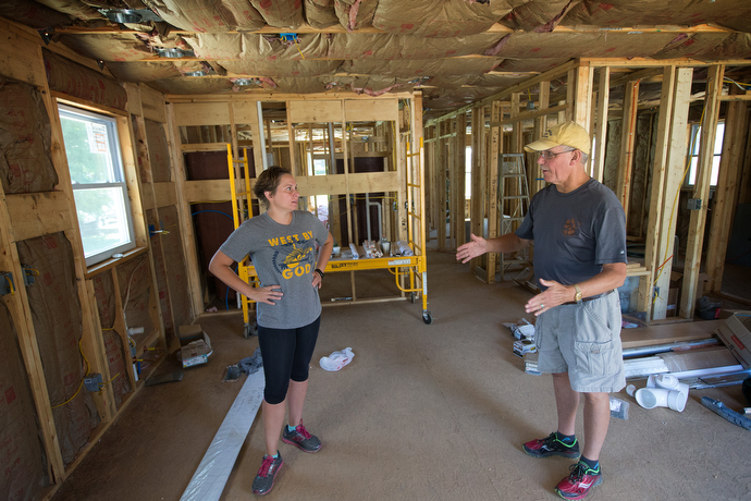 Margaret Tagwira Miranda Neighbors and the Rev. J.F. Lacaria check on the progress of a new home being constructed for a survivor whose home was destroyed by flooding in Clendenin, W. Va. Both work for the disaster recovery ministry of the West Virginia Conference of The United Methodist Church. Photo by Mike DuBose, UMNS.