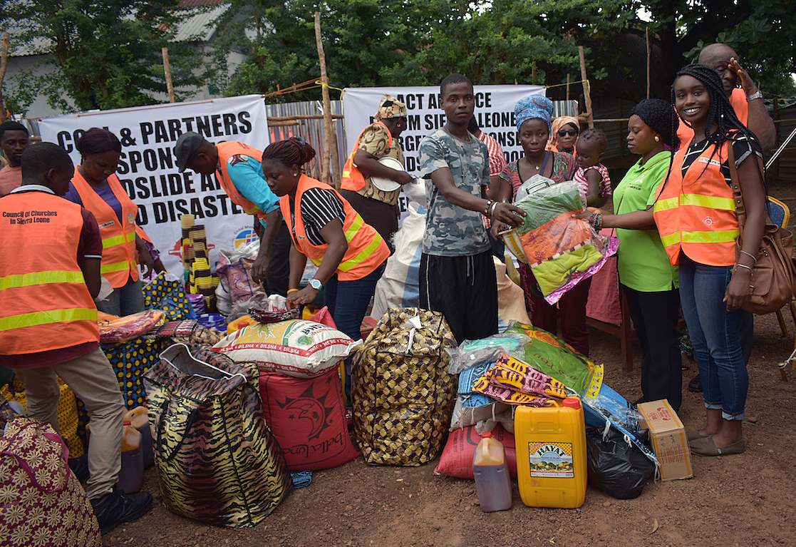 In September, the Council of Churches in Sierra Leone, led by United Methodist Bishop John Yambasu, distributed about $82,000 worth of food, bowls, blankets and other relief items to mudslide survivors at a new relocation camp in Juba, western Freetown. Photo by Phileas Jusu, UMNS.