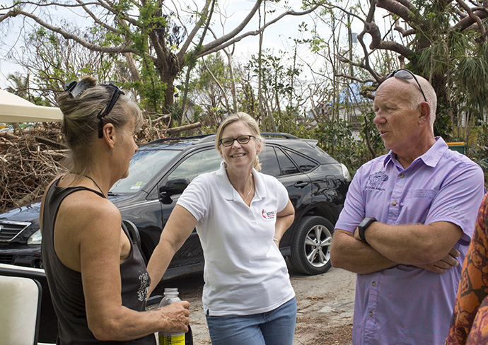 (From left) Denise Santos, the Rev. Laura Ice and Bob Cholka talk outside a Goodland distribution center located on the tip of Marco Island, Fla. Wesley United Methodist Church in Marco Island has reached out to the residents of the Goodland community. Santos is a volunteer from Goodland, Ice is recovery coordinator for the Florida Conference and Cholka is chairperson of the Wesley United Methodist Church council. Photo by Kathleen Barry, UMNS.