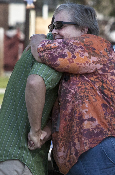 The Rev. C.J. Hill receives a hug from Pam Garrison, Florida conference disaster response coordinator, outside First United Methodist Church in Bonita Springs, Fla. Many of Hill's congregation suffered damage from Hurricane Irma. Photo by Kathleen Barry, UMNS.