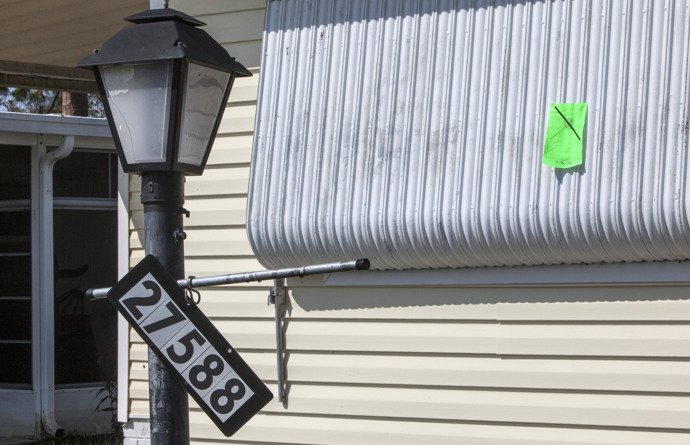A green sticker on a home Bonita Springs, Fla., signals that this home may be habitable in the future. Homes were marked with various colored stickers indicating degree of damage following Hurricane Irma. Photo by Kathleen Barry, UMNS.