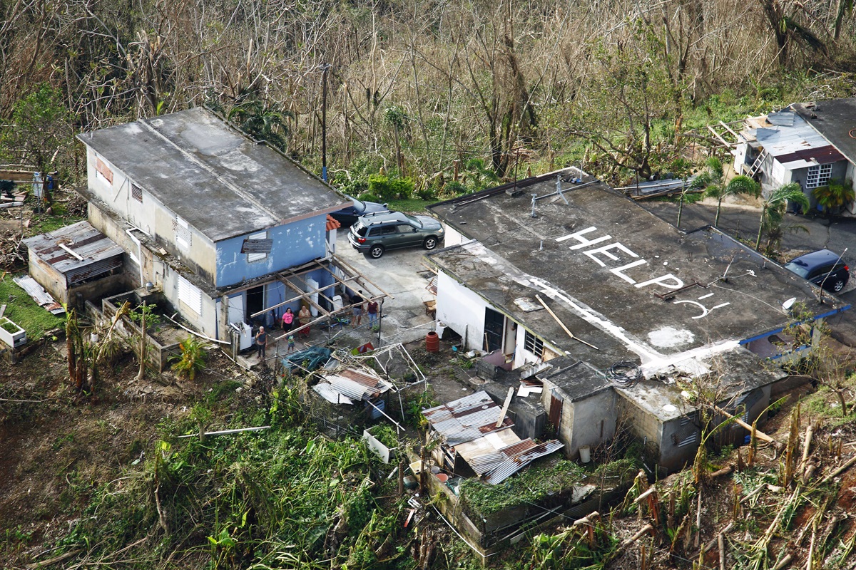 While conducting search and rescue in the mountains of Puerto Rico, a CBP (U.S. Customs Border Patrol) Air and Marine Operations Black Hawk located this home a half mile from the peak of a hill with HELP painted on its roof. Photo by Kris Grogan, U.S. Customs Border Patrol.