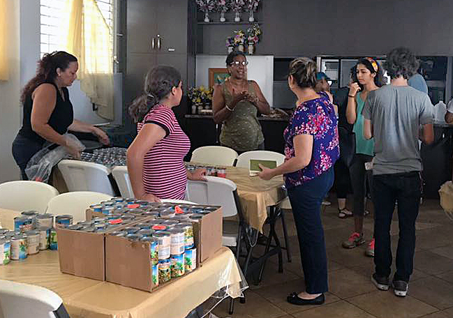 Volunteers from José Espada Marrero Methodist Church and Re-ACE (Rebuilding Communities with Hope), a community outreach program, pack 100 bags of food to distribute in the town of Maunabo in Puerto Rico. The Methodist Church of Puerto Rico is partnering with Re-ACE and The United Methodist Church and UMCOR to help gather provisions and coordinate distribution at different sites Photo courtesy of the Facebook page of Bishop Hector F. Ortiz.