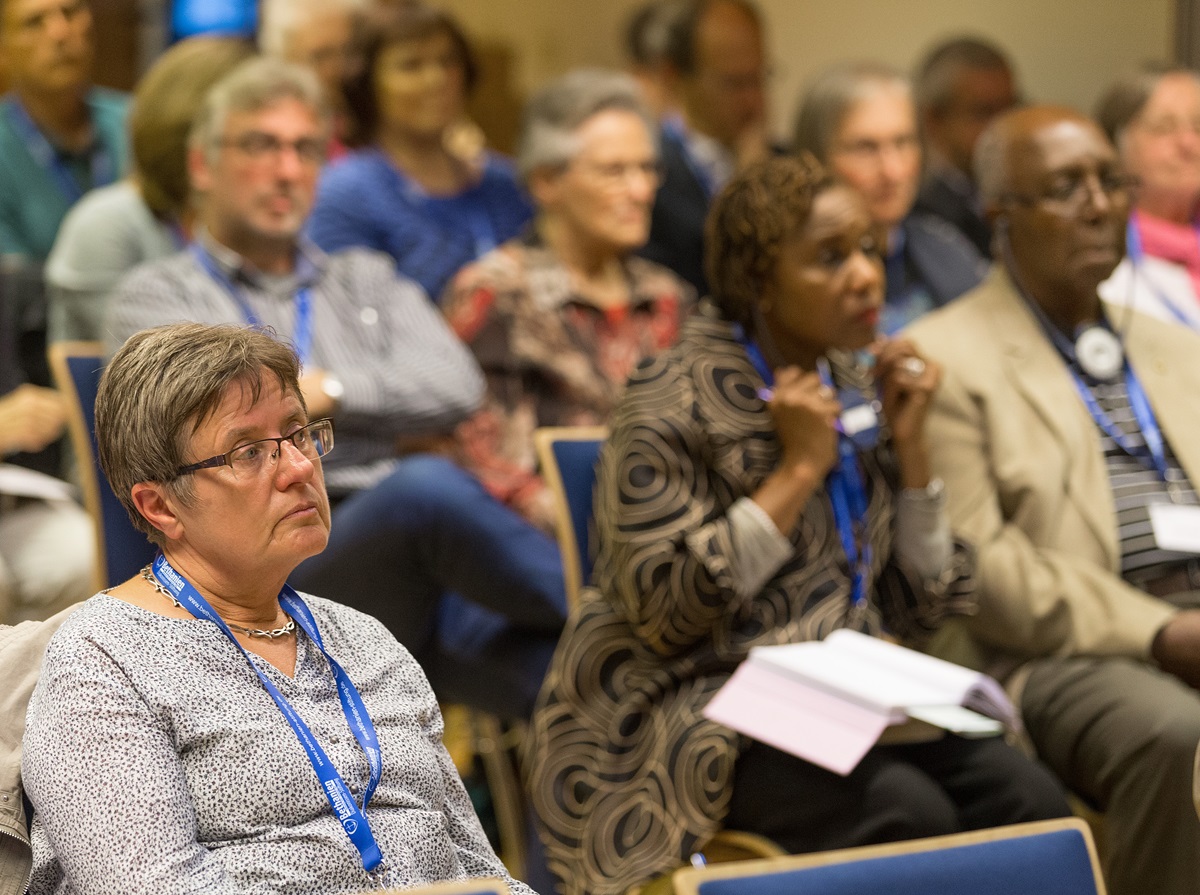 Participants, some using translation equipment, listen to a presentation at the International Health Forum of The United Methodist Church in Stuttgart, Germany. Photo by Mike DuBose, UMNS.