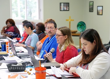 Sara Hotchkiss, in red, speaks during the Commission on General Conference meeting Oct. 7 at Camp Sumatanga in Gallant, Ala. Earlier in the meeting, Hotchkiss helped explain plans for the special General Conference in 2019. Photo by Heather Hahn, UMNS.  Sara Hotchkiss, in red, speaks during the Commission on General Conference meeting Oct. 7 at Camp Sumatanga in Gallant, Ala. Earlier in the meeting, Hotchkiss helped explain plans for the special General Conference in 2019. Photo by Heather Hahn, UMNS.