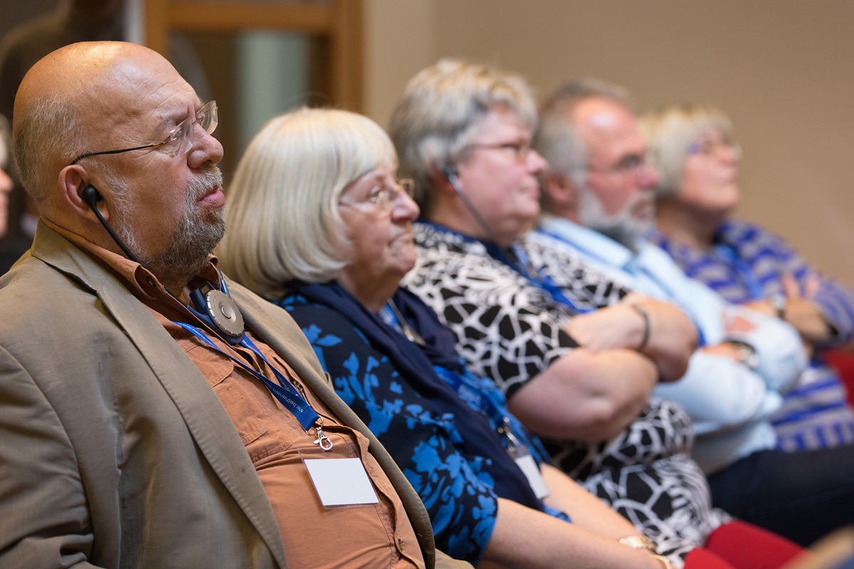Participants, some using translation equipment, listen to a presentation at the International Health Forum of The United Methodist Church in Stuttgart, Germany. Photo by Mike DuBose, UMNS.