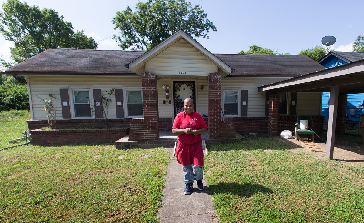 Debra Kelley walks out of her house preparing to go to work. She says having a key to her own front door is a precious gift. Photo by Mike DuBose, UMNS.