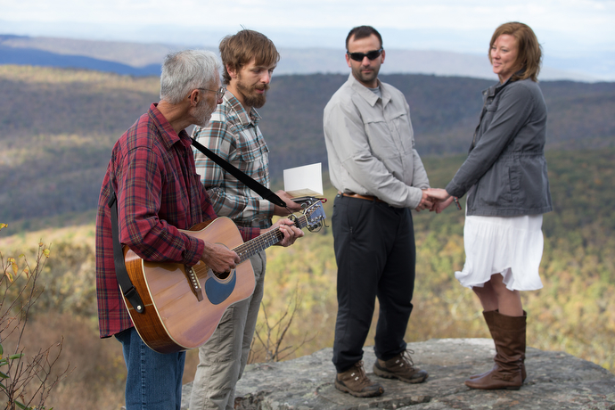 Nick and Stephanie Houle renew their wedding vows atop Sugar Run Mountain, just off the Appalachian Trail near Pearisburg, Va. Officiating are United Methodist pastors Alan Ashworth (left) and Matt Hall. Ashworth leads two churches in nearby Bland County, Va., and helped found the Appalachian Trail Outreach Ministry. 