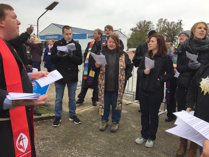 The Rev. Eric Little, United Methodist pastor, led clergy in singing hymns such as “Amazing Grace” and “This Little Light of Mine.” Little said, “The songs were our sermon.” Photo by Heather Hahn, UMNS.