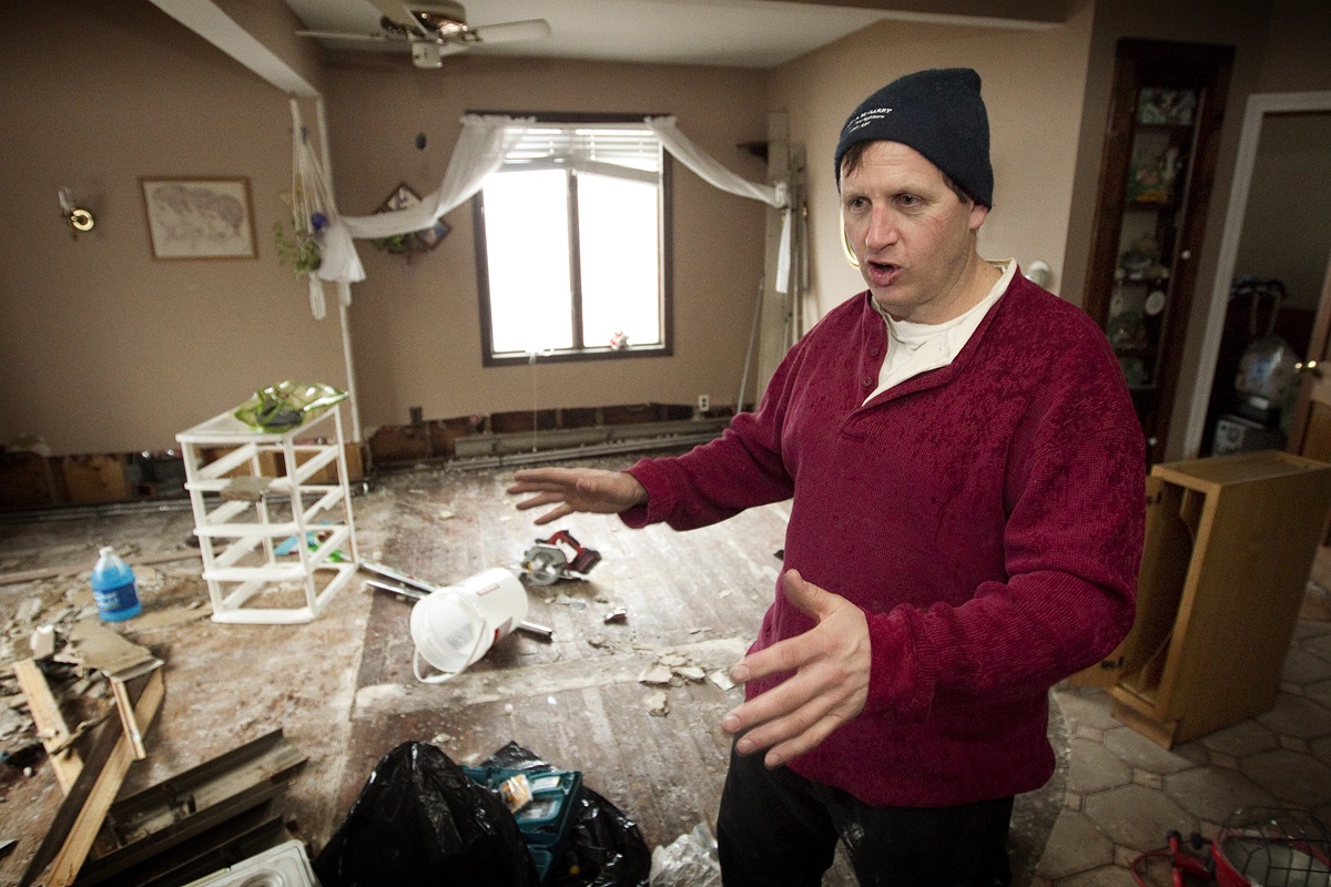 As the storm’s first anniversary approached, Peter Vasquenz describes damage to his mother's home in the Staten Island borough of New York following Hurricane Sandy in November 2012. Vasquenz, a firefighter in Brooklyn, had been ripping out waterlogged drywall and flooring. File photo by Mike DuBose, UMNS.