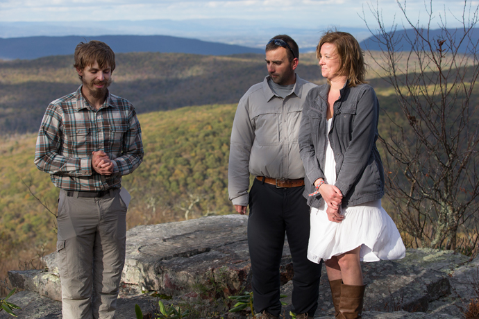 The Rev. Matt Hall (left) prays at a renewal of vows for Nick and Stephanie Houle on Sugar Run Mountain, just off the Appalachian Trail near Pearisburg, Va.