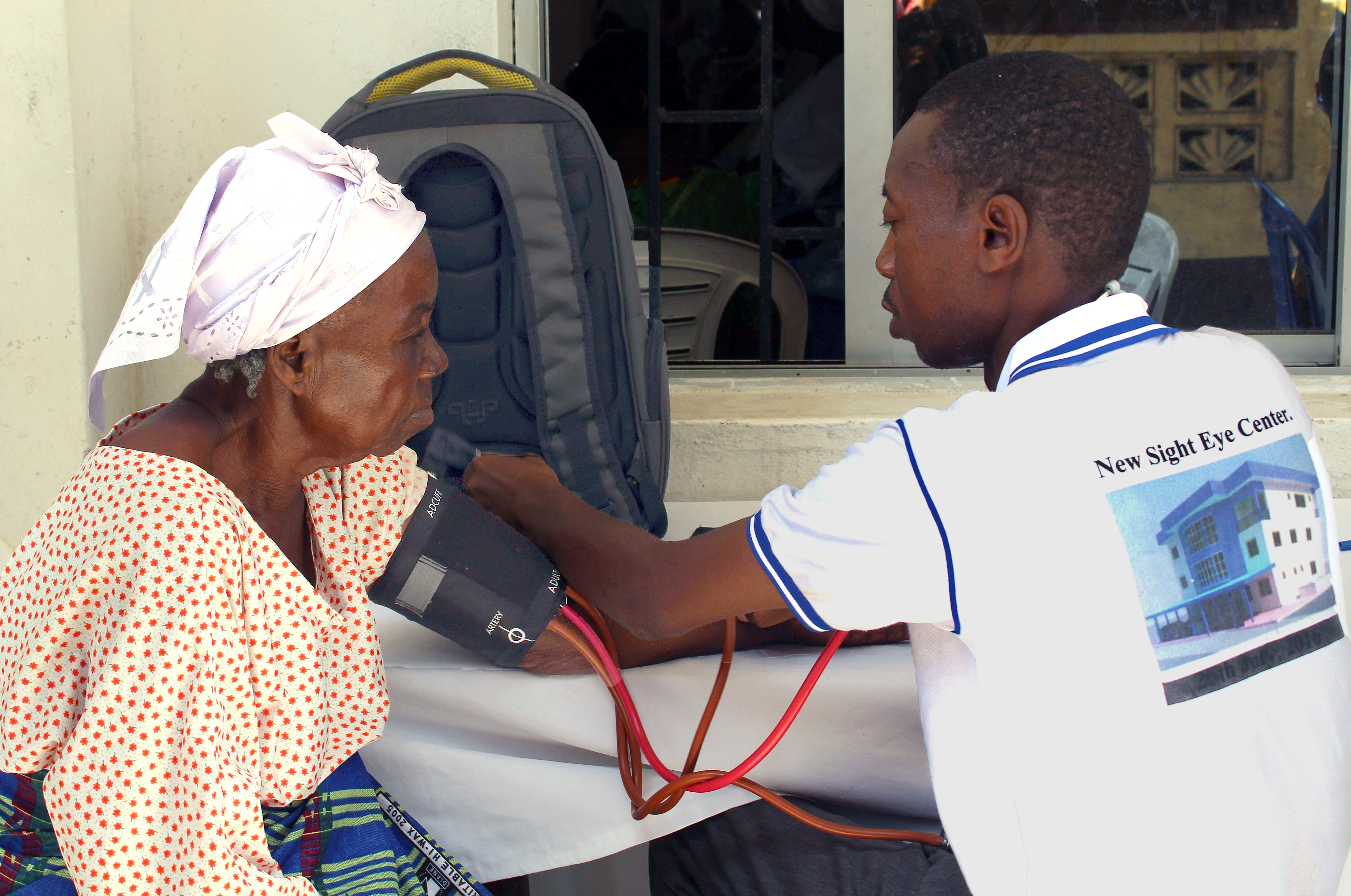 A staff member of the New Sight Eye Center in Liberia checks vitals on one of the senior citizens who benefited from free clinical health services provided by The United Methodist Church’s Aging Ministry. The clinic was part of the activities for Senior Citizens Sunday sponsored by the Liberia Conference, and benefitted hundreds of seniors. Photo by Julu Swen, UMNS.