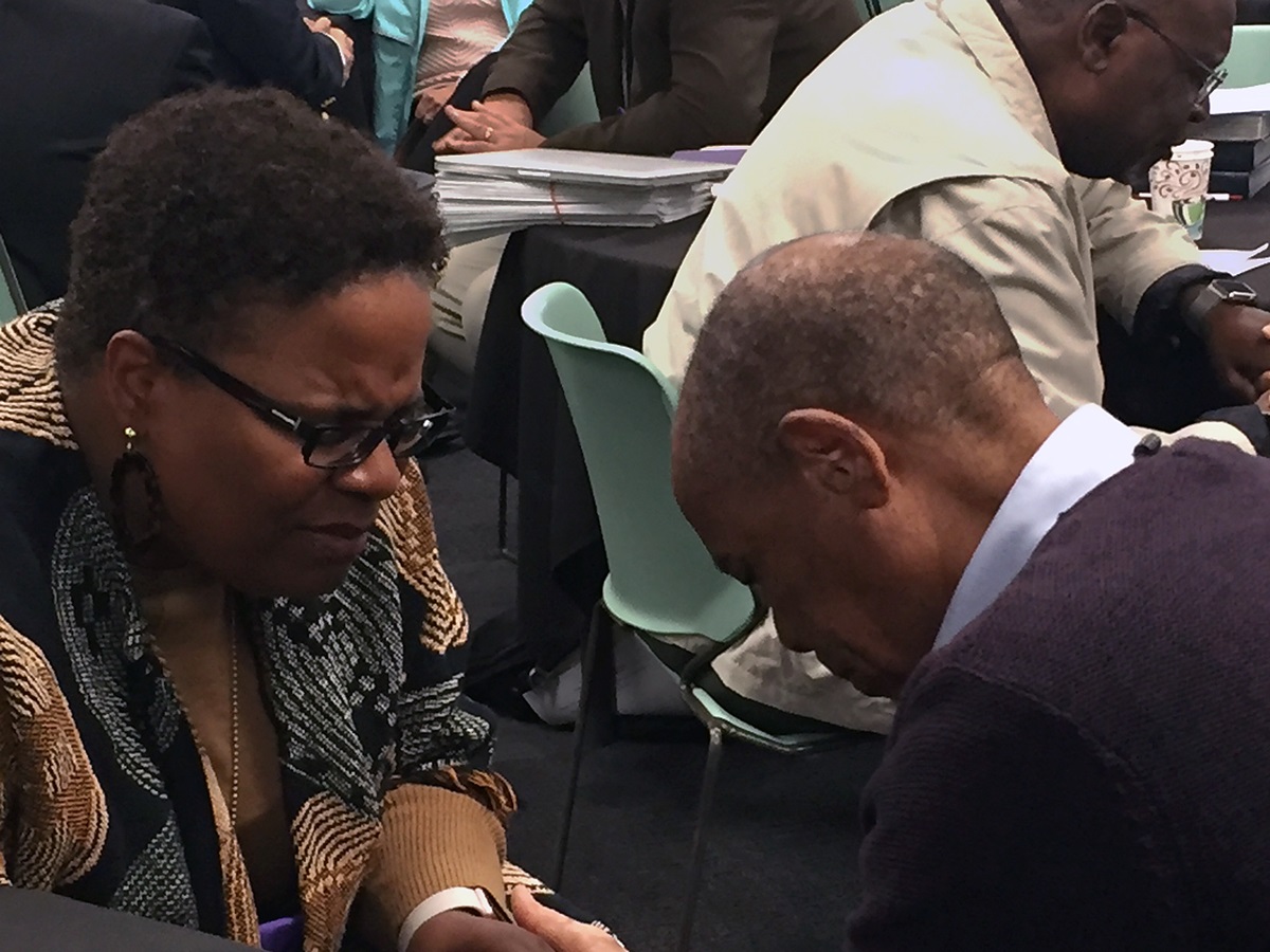 Baltimore-Washington Area Bishop LaTrelle Easterling, at left, prays with Zimbabwe Area Bishop Eben K. Nhiwatiwa during worship at the Council of Bishops meeting.  African bishops, including Nhiwatiwa, have issued a pastoral letter. Photo by Heather Hahn, UMNS.
