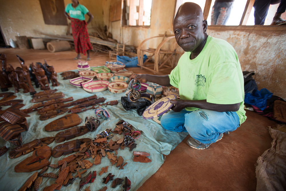 John Farr displays carvings and baskets that he makes to help support himself at the Ganta Leprosy and TB Rehab Center. The center is part of the United Methodist Ganta Mission Station in Ganta, Liberia. Photo by Mike DuBose, UMNS.