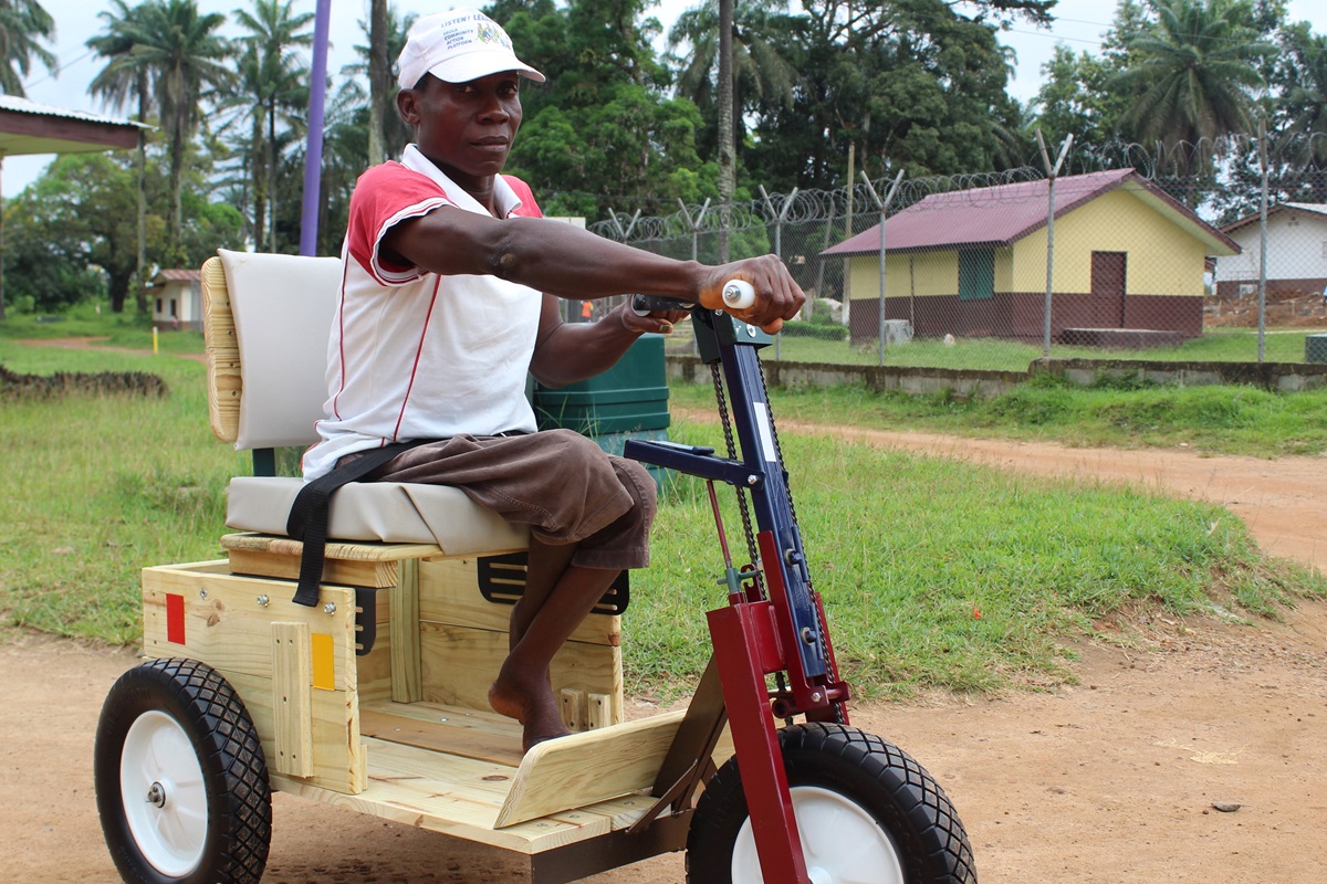 Abel Gbeadquoi sits on his Personal Energy Transportation vehicle, a gift from the United Methodist Women in Liberia. Photo by Julu Swen, UMNS.