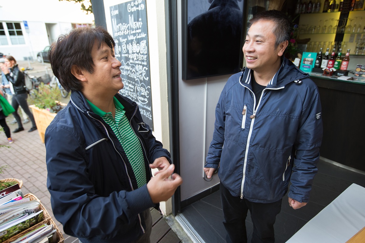 The Rev. Chi My Nguyen (left) visits with parishioner Nguyen Trung Dung at his sushi restaurant in Frankfurt, Germany.  Nguyen is the only Vietnamese United Methodist pastor in Germany, serving a church of about 40 immigrants in Frankfurt. Photo by Mike DuBose, UMNS.