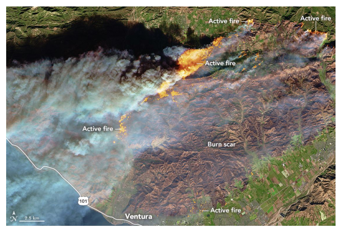 A NASA satellite image shows active fires affecting a forested, hilly area north of Ventura, with flames encroaching into the northern edge of the city. On Dec. 6, 2017, Cal Fire estimated that at least 12,000 structures were threatened by fire. 