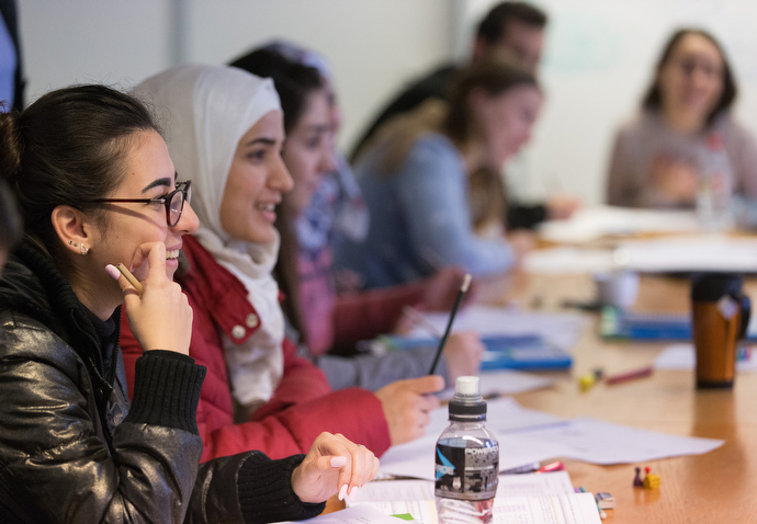 Recent immigrants work on exercises during their German class at Erlöserkirche Evangelisch-methodistische (United Methodist Church of the Redeemer) in Bremen, Germany. Photo by Mike DuBose, UMNS.