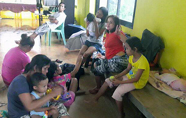 Women and children take sanctuary inside the Light and Life United Methodist Church in Tacloban City, Philippines, after Typhoon Urduja, also known as Kai-Tak, struck the area on Dec. 16. Three persons reportedly died and thousands of families were driven from their homes by floods and landslides. Photo courtesy of Iris Picardal-Terana and Ronnel Tuscano de Juan, Light and Life United Methodist Church.