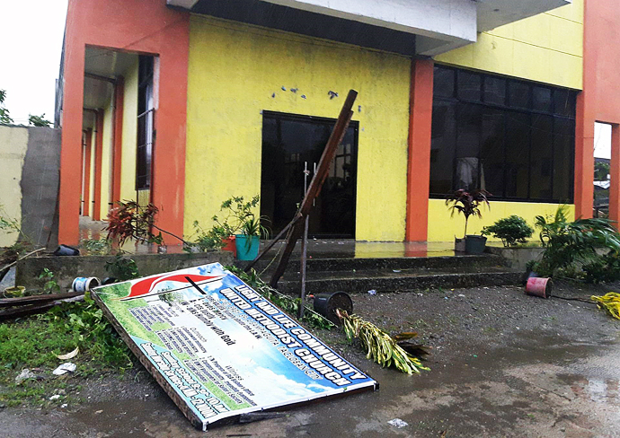 The sign for the Light and Life United Methodist Church in Tacloban City, Philippines, lies on the ground in front of the building after Typhoon Urduja brought strong winds and rain to the area on Dec. 16. The church served as an evacuation place for church members and some six families from the community whose houses were flooded. Photo courtesy of Iris Picardal-Terana and Ronnel Tuscano de Juan, Light and Life United Methodist Church.