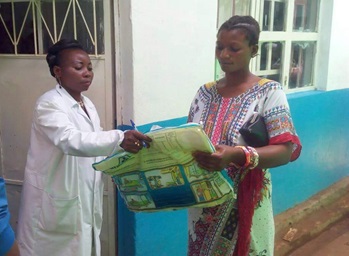 Anny Butunga Mwindulwa distributes a mosquito net to new mother Aziza Rachel outside the Irambo Clinic maternity ward in Bukavu, Democratic Republic of Congo. Photo by Philippe Kituka Lononga, UMNS. Anny Butunga Mwindulwa distributes a mosquito net to new mother Aziza Rachel outside the Irambo Clinic maternity ward in Bukavu, Democratic Republic of Congo. Photo by Philippe Kituka Lononga, UMNS.
