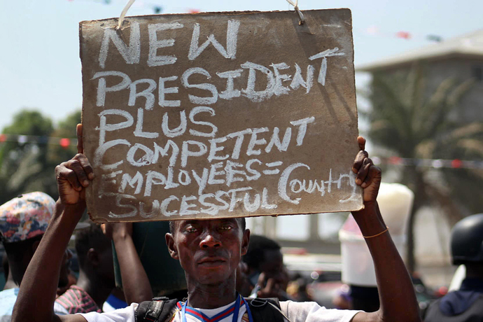 A spectator at the inauguration for Liberian President George Manneh Weah holds a sign stating his hopes for the country’s future. Photo by E Julu Swen, UMNS.