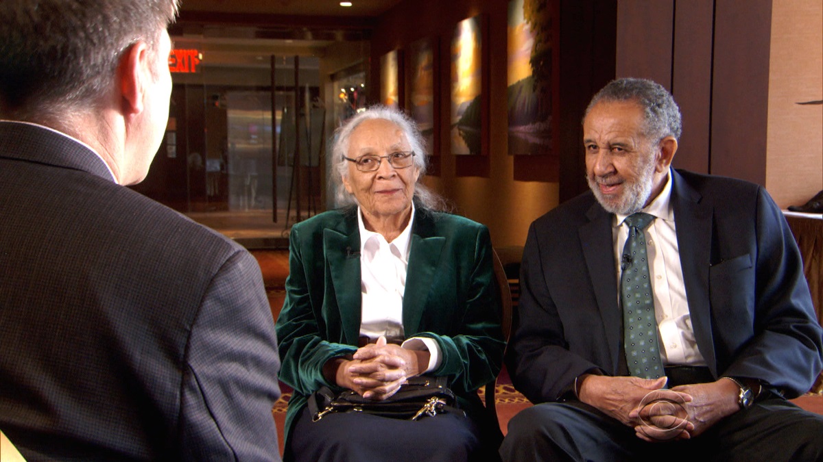 The Rev. Gilbert H. Caldwell and his wife, Grace, are interviewed by Steve Hartman for an episode of “On the Road” at the site of where they had been denied lodging 60 years earlier. The Caldwells were turned away from the resort in the Poconos on their honeymoon because of their race. Photo courtesy of “On the Road,” CBS News.