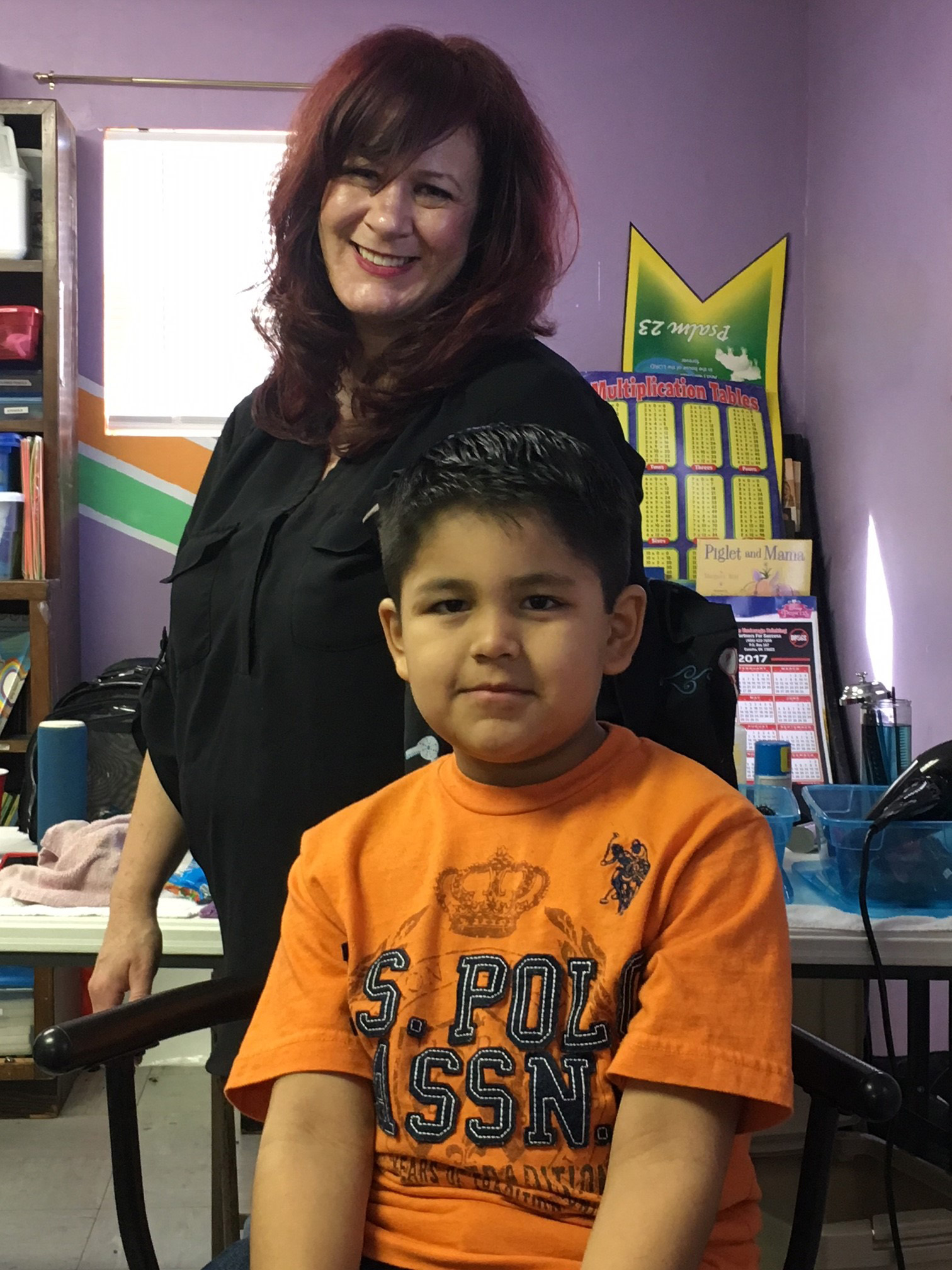 Native American children receive free back-to-school haircuts from Nikki Humbles, a licensed cosmetologist from Brock, Texas, on Jan. 27, 2018, at Clinton Church and Community Center. Humbles says she finds great joy in working with the children and families and hopes to make this an annual event. Photo courtesy of Clinton Church and Community Center.