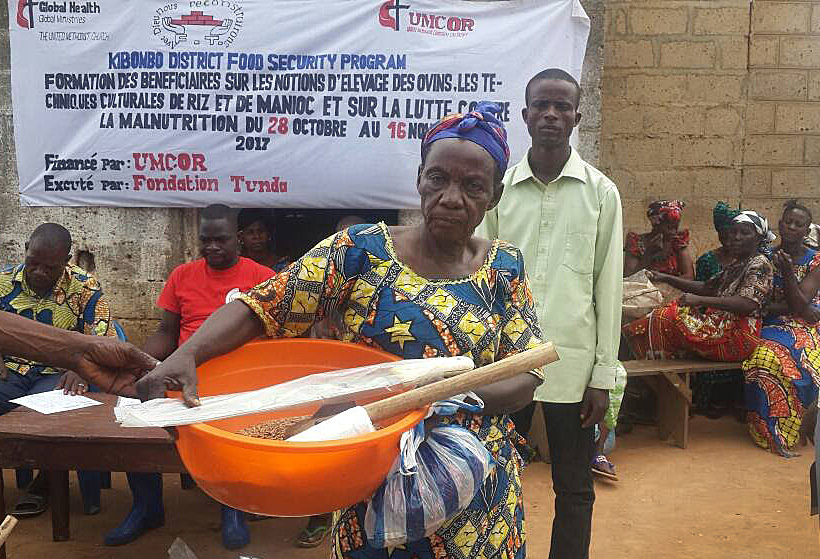 The president of United Methodist Women in Kibombo, known as “Mama Faila,” carries items received as part of a food security project sponsored by the Global Health unit of the Board of Global Ministries and the Tunda Foundation. The 12-month project was launched in September and targets United Methodists from 10 local churches. Photo courtesy of the East Congo Annual Conference.