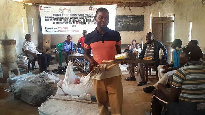 A man carries a machete, a hoe and samples of cassava cuttings that were distributed to United Methodists in Kibombo in October to help farmers improve agricultural production. Photo courtesy of the East Congo Annual Conference.