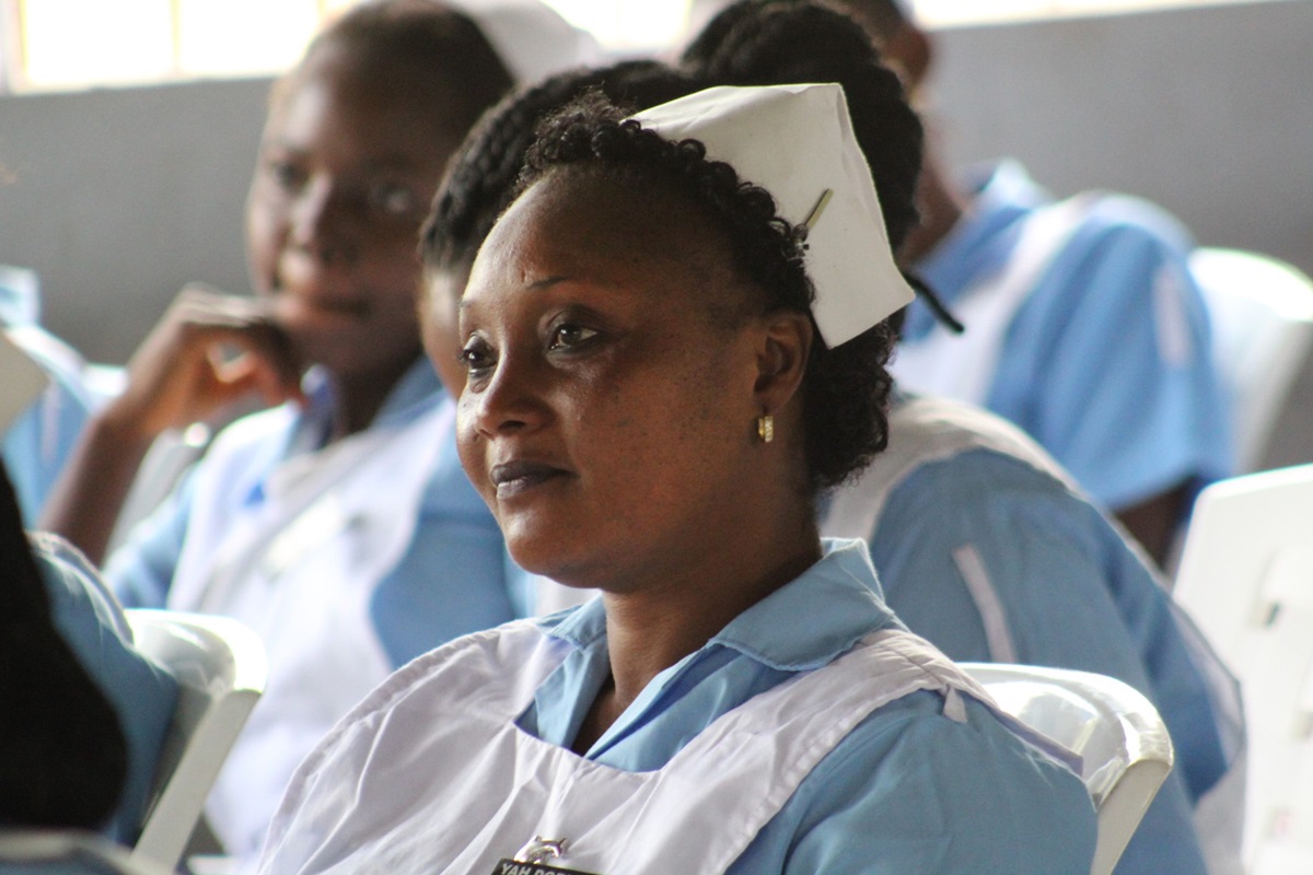 Yah Dorliea, a United Methodist University nursing student, listens intently during a ceremony consecrating the new nursing school in Ganta, Liberia. The school is part of the Winifred J. Harley College of Health Sciences. Photo by E Julu Swen, UMNS. 