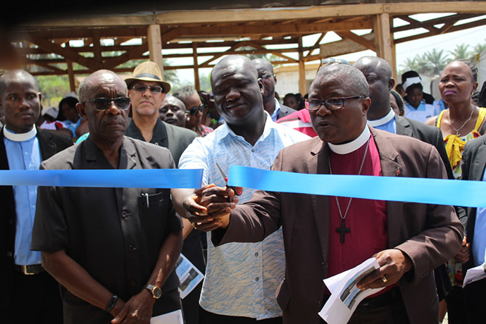 Bishop Samuel J. Quire Jr. cuts the ribbon to the new United Methodist University nursing school facilities in Ganta, Liberia. The school is the first College of Health Sciences department to relocate from Monrovia. Photo by E Julu Swen, UMNS. 