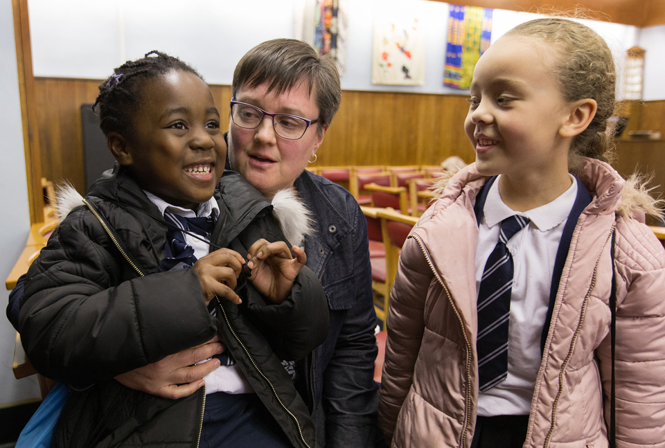 Nwarebea Baffoe (left) and Rebecca Henry, both age 6, stop by after school to visit with the Rev. Janet Corlett at Bermondsey Central Hall Methodist Church in London.  Photo by Mike DuBose, UMNS.