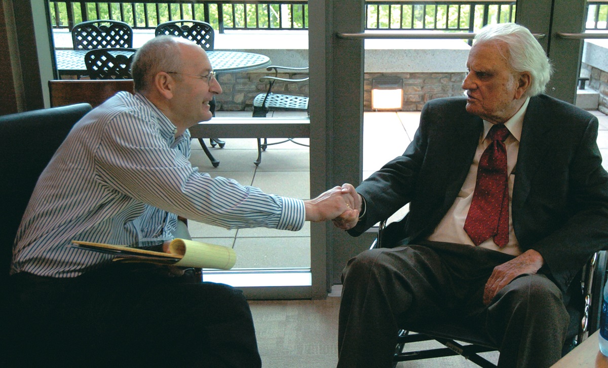 Writer and photographer Ken Garfield shakes hands with the Rev. Billy Graham. Garfield, who wrote a book, “Billy Graham-A Life in Pictures,” is the director of communications at Myers Park United Methodist Church in Charlotte, North Carolina. Photo courtesy of Triumph Books/The Charlotte Observer.