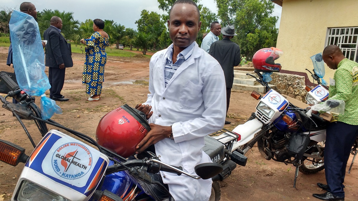 Dr. Kaly Kayamba Tombe sits on a motorbike delivered by the North Katanga Conference. The United Methodist Board of Global Ministries’ Global Health unit provided funding for the bikes, as well as computers, mobile phones and modems, to improve patient care and data collection in Kamina, Democratic Republic of Congo. Photo by the Rev. Betty Kazadi Musau, UMNS