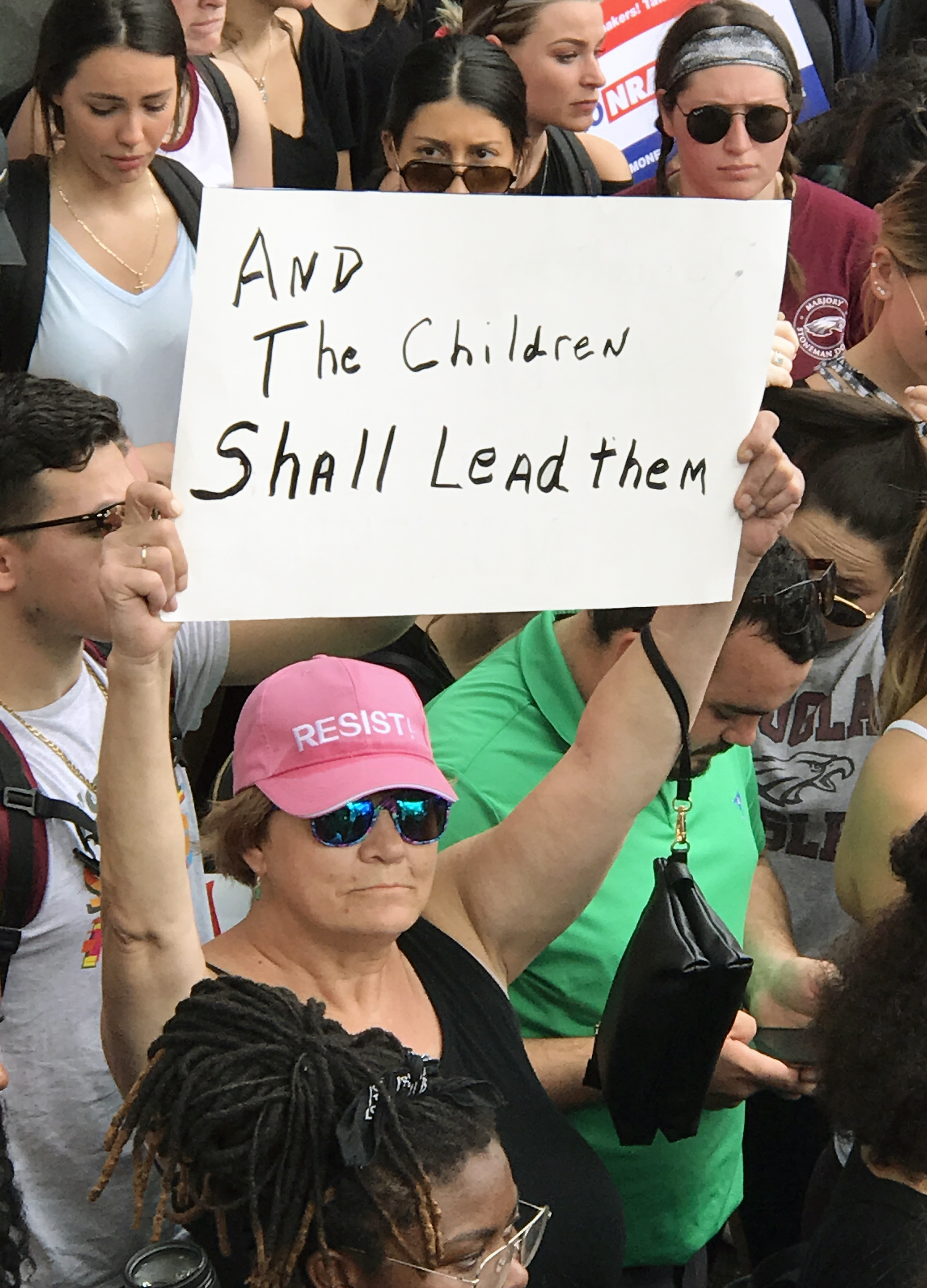 The sign held by a demonstrator at a rally for stricter gun laws at the state capitol in Tallahassee, Florida, references the biblical verse from Isaiah 11:6. The Feb. 21 demonstration occurred after 17 people died in a mass shooting in Parkland. Photo by the Rev. Andy Oliver.