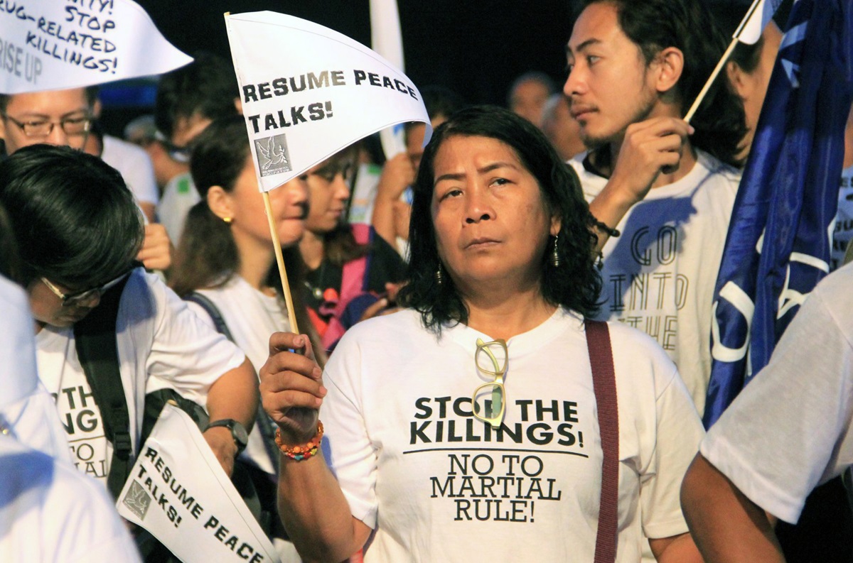 Ofelia A. Cantor, a laywoman from Village United Methodist Church, holds a sign asking for peace talks to resume at the Walk for Life rally Feb. 24 in Manila, Philippines. United Methodists joined the ecumenical gathering to protest Philippine President Rodrigo Duterte’s war on drugs. Photo courtesy of Jsr Grafix.