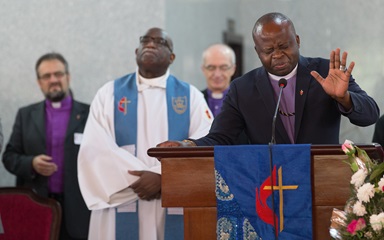 Bishop Mande Muyombo (right) prays at Canaan United Methodist Church in Abidjan, Côte d'Ivoire, where members of the Standing Committee on Central Conference Matters worshipped during their meeting. One issue before the group is where to place five new bishops in Africa. Mande, who serves in Democratic Republic of Congo and is the denomination’s most recently elected bishop, is joined by (from left) Bishops Harald Rückert, Gregory Palmer and Patrick Streiff. Photo by Mike DuBose, UMNS. Bishop Mande Muyombo (right) prays at Canaan United Methodist Church in Abidjan, Côte d'Ivoire, where members of the Standing Committee on Central Conference Matters worshipped during their meeting. One issue before the group is where to place five new bishops in Africa. Mande, who serves in Democratic Republic of Congo and is the denomination’s most recently elected bishop, is joined by (from left) Bishops Harald Rückert, Gregory Palmer and Patrick Streiff. Photo by Mike DuBose, UMNS.