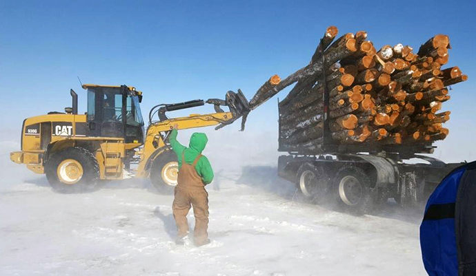 The most urgent needs are for food and firewood. Semi-trucks filled with long pine logs are delivered which volunteers then cut, split and deliver to homes in remote locations on the Blackfeet Nation. Photo courtesy of Whitefish United Methodist Church.
