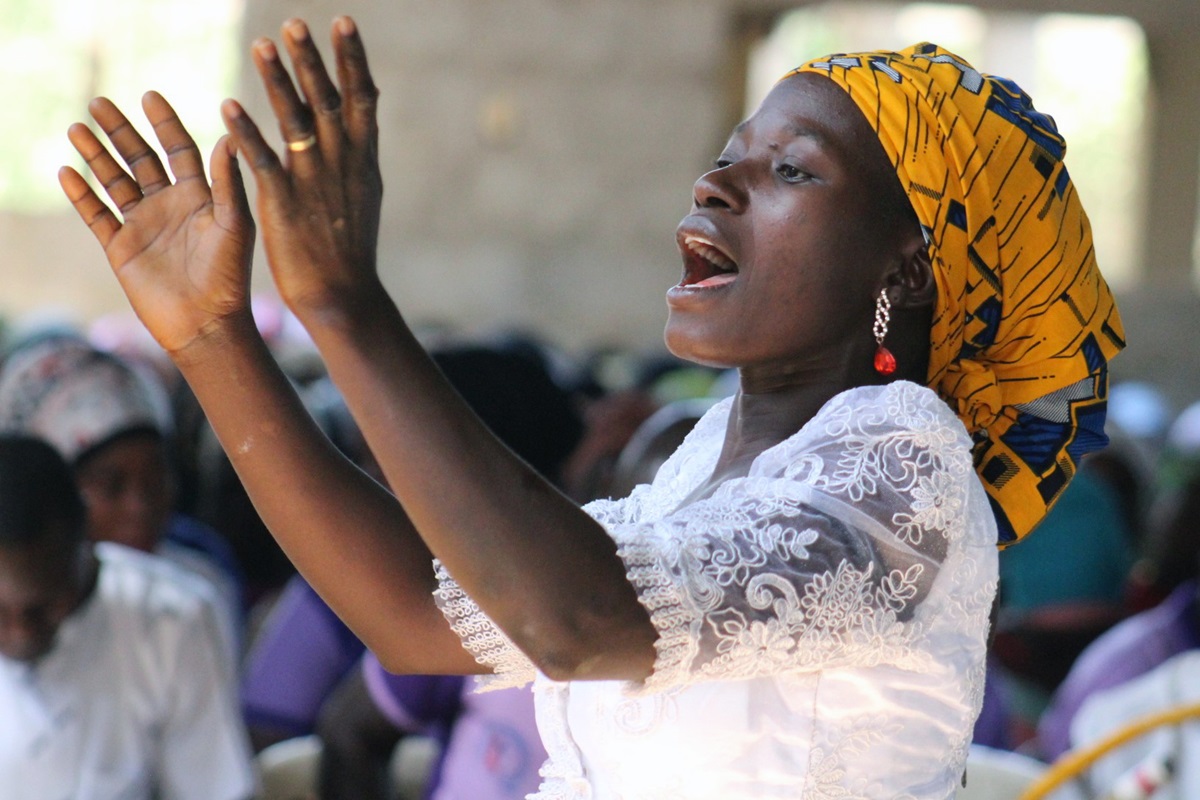 Evelyn Lot directs the Women Fellowship Choir during worship at Abuja Area 1 United Methodist Church in Abjua, Nigeria, March 4, 2018. The church is facing the threat of a federal government penalty for failing to meet construction deadlines due to a lack of funds to complete the structure. Photo by E Julu Swen, UMNS.
