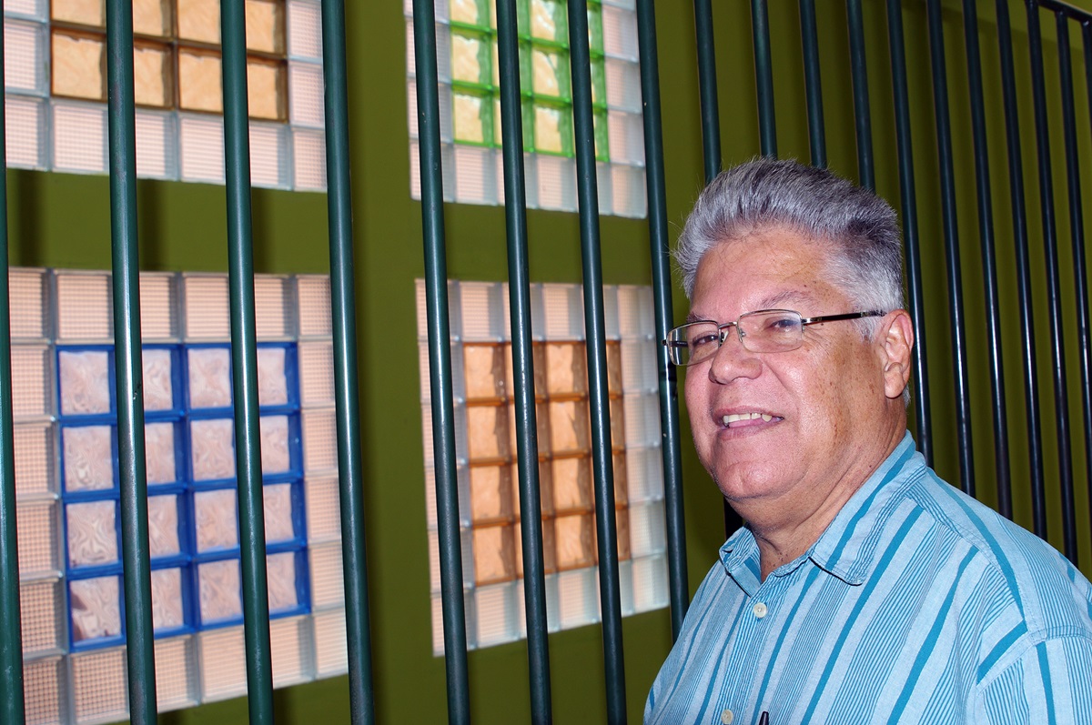 The Rev. José Roberto Peña stands by a glass display he designed for the Central United Methodist Church of Danlí's expansion building. The building has several rooms for Bible Sunday school classes and other ministries the church does for the community. Photo by Gustavo Vasquez, UMNS