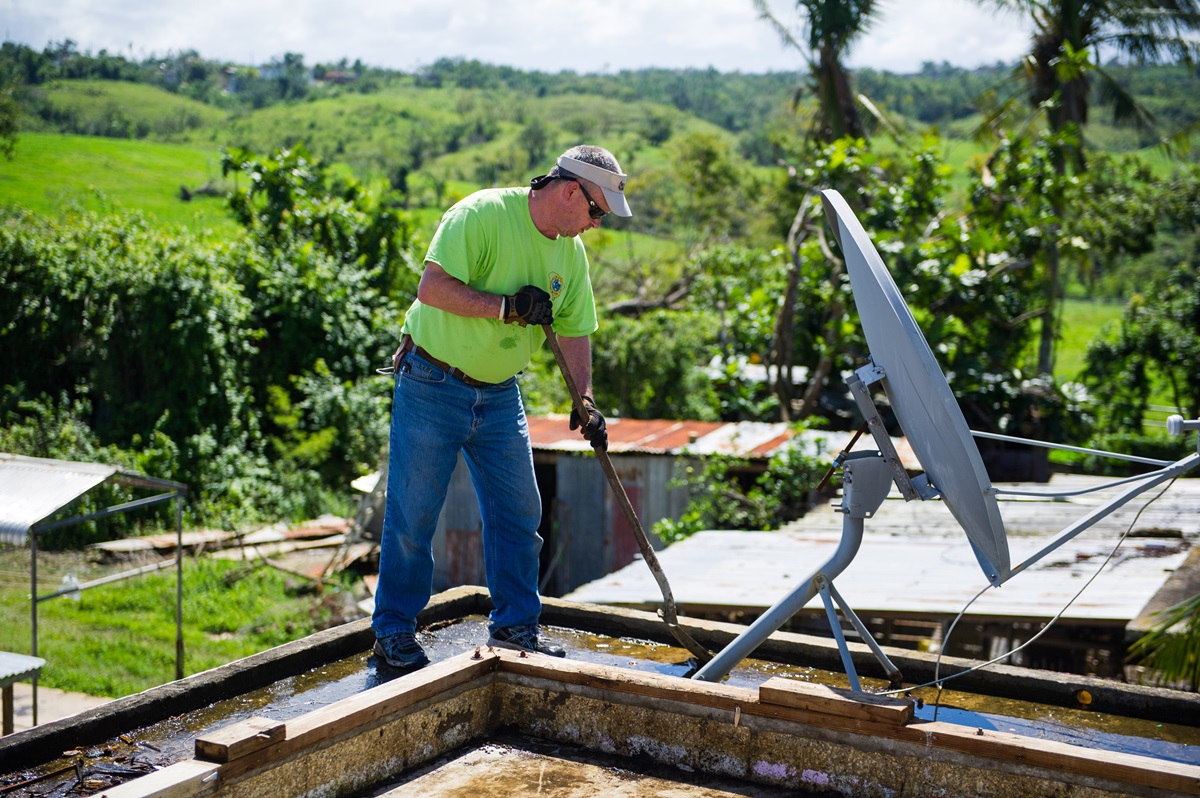 David Ivey mucks out the second floor of a damaged home in Hatillo, Puerto Rico, a town known for having as many cows as people. Photo by Matt Brodie.
