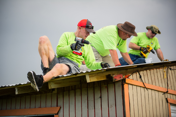 Members of a volunteer team from the South Carolina Conference install a new metal roof on a hurricane-damaged roof in Hatillo. From left are: Nate Gibson, the Rev. Mike Evans and Matt Brodie. The team of ten spent eight days in northern Puerto Rico, which was devastated last fall by back-to-back hurricanes. Photo by Jessica Brodie.