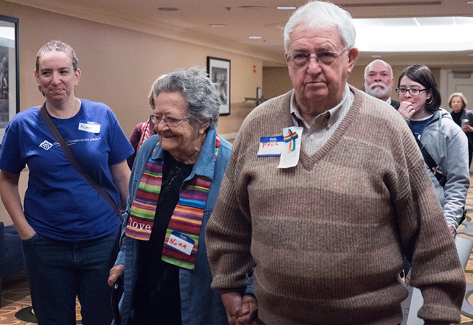 Nora and Paul Meredith, parents of the Rev. David Meredith, walk to hearing concerning their son held March 9 in Indianapolis Hilton. 
