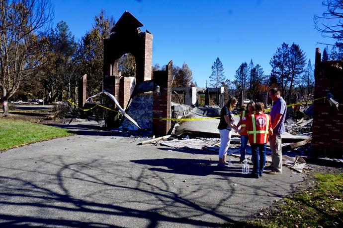 Peggy Busick (left), and her husband, the Rev. Blake Busick (far right), pray with the Rev. Katherine Shoen (second from left), associate pastor, Redwood Covenant Church, and Diana Tollerud, Salvation Army staff, who were in the Santa Rosa, California, neighborhood providing support and care to those affected by wildfires. Photo by Sue Larson, courtesy of the Rev. Blake Busick.