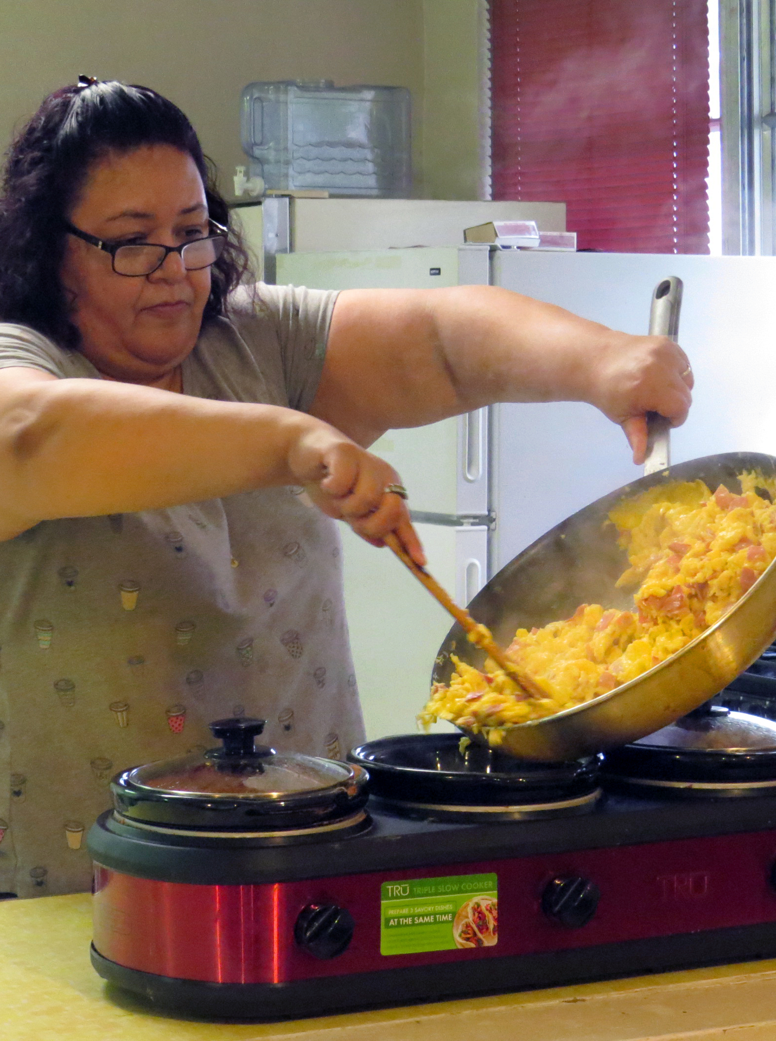 Up early on Sunday mornings, the Rev. Liliana Padilla cooks breakfast for the 9:30 a.m. Taco Service at San Pablo United Methodist Church, in Pearsall, Texas. She preaches at the 11 a.m. service. Photo by Sam Hodges, UMNS.